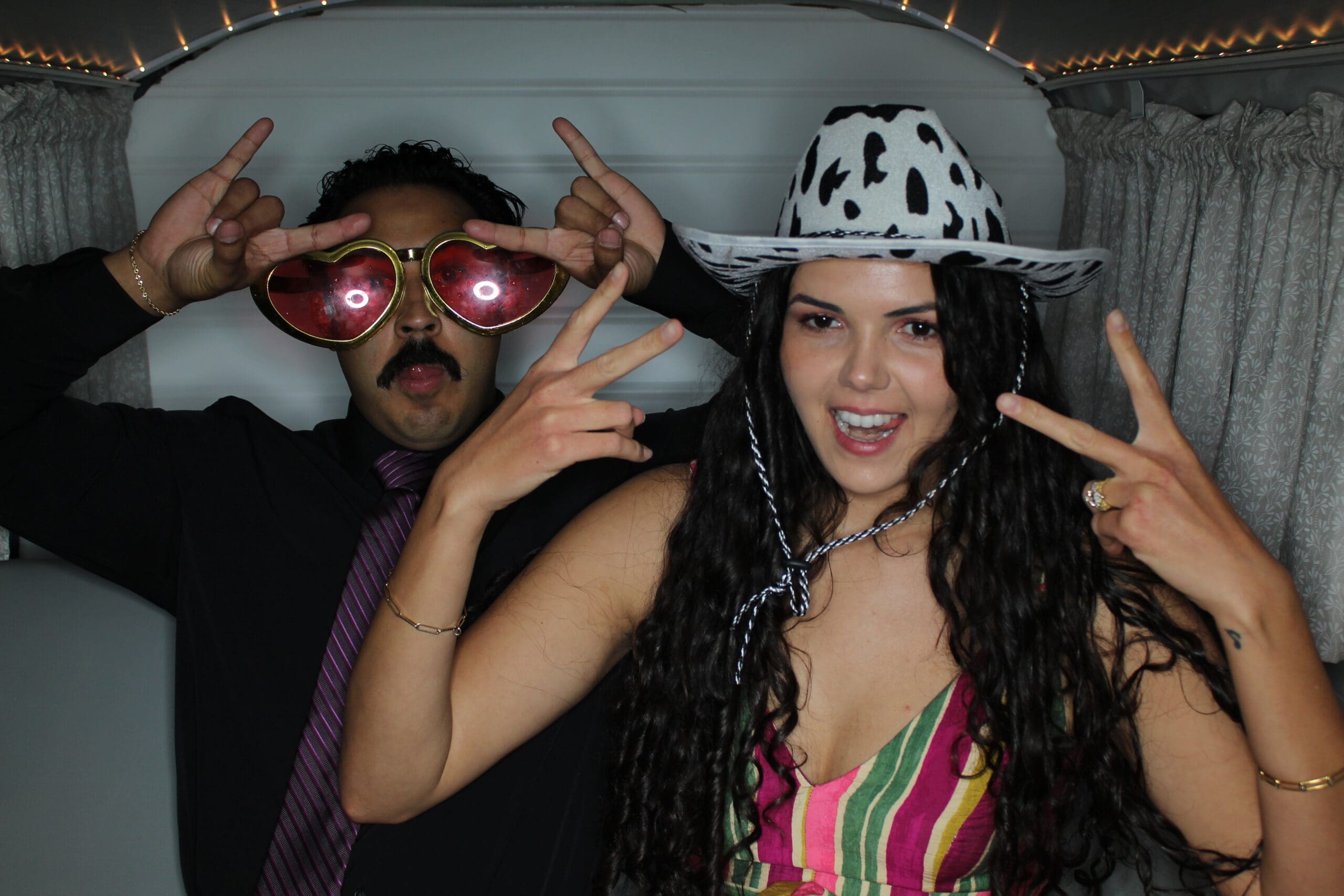 Party people making sill faces at the photo booth housed in Denver Photo Booth at a wedding